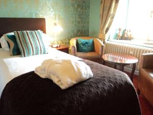 兰彼得法尔肯代尔酒店&餐厅的配有一张床和一把椅子的酒店客房