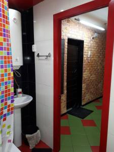 KanskАпартаменты двухкомнатные的一间带红色门的浴室和一间带水槽的浴室