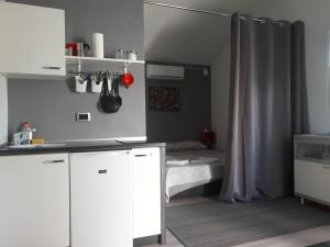 普耶斯察纳乌瓦拉Studio Apartman Splash的一间厨房,配有白色的橱柜和一张位于客房内的床