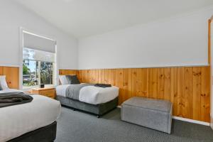 Taranna马森斯小屋公寓的酒店客房设有两张床和窗户。