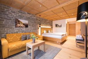 伊施格尔Alpenhotel Ischglerhof的客厅配有沙发和1张床