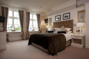 惠茨特布尔海洋酒店的一间卧室设有一张大床和两个窗户。