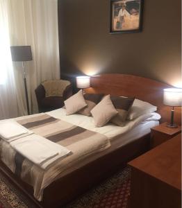 布罗德尼察U Bosmana的一张大床,位于酒店带两盏灯的房间