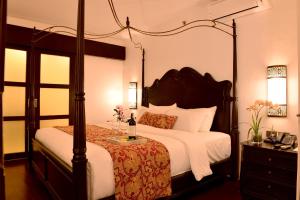 长滩岛长滩岛夏季宫殿酒店的卧室配有一张带白色床罩的天蓬床