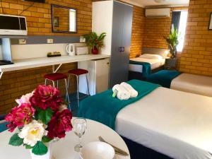 科夫斯港泊桑汽车旅馆的酒店客房,设有两张床和一张鲜花桌。
