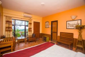 纳加阔特都蒙咖啡小屋和平酒店的一间卧室设有橙色的墙壁、一张床和一张书桌