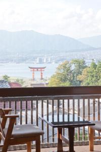 宫岛菊野屋酒店的观景阳台的桌子和长凳