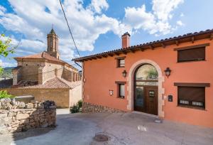 CublaEl Castillo de Celia的一座橙色的建筑,设有门和教堂