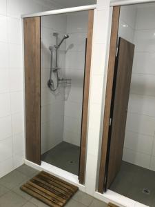 珀斯海伊街旅行者旅舍的浴室里设有玻璃门淋浴
