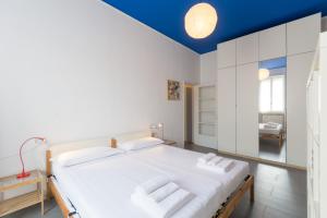 米兰达塞纳假日及商务会所公寓的卧室配有一张白色大床和蓝色天花板