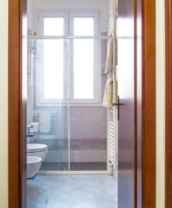穆拉诺casa dei nonni的带淋浴和卫生间的浴室以及窗户。