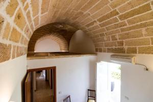 图列马塞里亚卡里纳尼乡村民宿的一间设有砖墙和拱门的房间