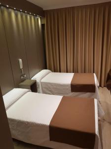 赫塔费科隆旅舍的酒店客房设有两张床和窗户。