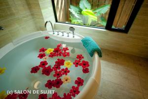 名户Bougain Terrace Resort Ta-chi House的浴缸里布满红色和黄色的花卉
