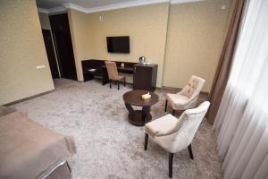 瓦纳佐尔Laguna Hotel的酒店客房配有桌椅和电视。
