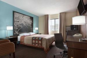 芒特弗农Super 8 by Wyndham Mount Vernon, IL的配有一张床和一张书桌的酒店客房