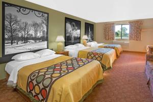 Howe豪速8酒店的酒店客房,设有三张带黄床单的床