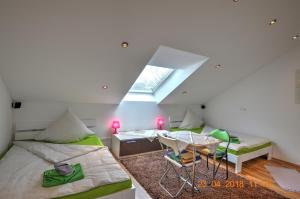 基希海姆Ferienwohnung"VIP MUNICH ALBATROS DE LUXE"的客房设有两张床、一张桌子和一扇窗户。