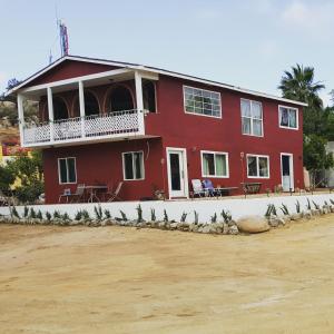 瓜达鲁佩镇Villa De Coral的前面有一群鸟的红色房子
