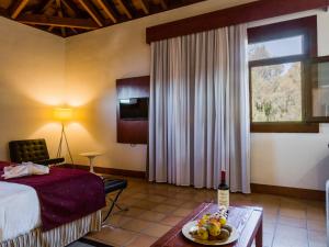 桑蒂亚戈德尔泰德卡索那德尔庭院旅馆的酒店客房设有一张床和一张带果盘的桌子。