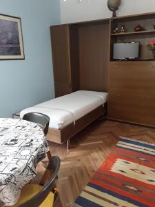 奥斯塔Appartamento Fantasia CIR Aosta 0241的一间小卧室,配有一张床和一张桌子