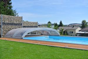 圣温德尔Ferienwohnung Jucarm的一座游泳池,上面有一座玻璃桥
