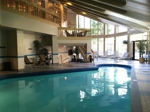 比弗河Park Plaza Beaver Creek的酒店的大型游泳池配有桌椅