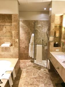 开普敦Taj HotelApart, Taj Hotel Cape Town的带淋浴、盥洗盆和浴缸的浴室
