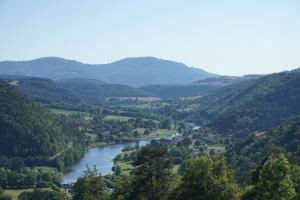 BeauzacChambres et table d’hôtes le Barret的一条河流穿过山区的山谷