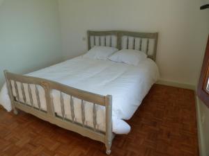 LainsecqJolie maison de campagne的一张带白色床单和枕头的床