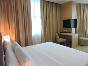 哥打京那巴鲁Hotel N°5的酒店客房配有一张床和一张书桌及一台电视