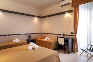 雷卡纳蒂港蒙帝亚尔酒店的酒店客房设有两张床和一张桌子。