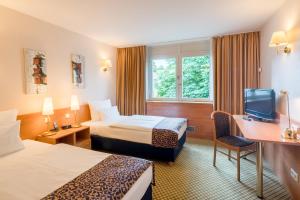 费尔巴赫斯图加特菲尔巴赫贝斯特韦斯特酒店的酒店客房设有两张床和电视。