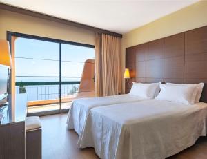 卡尼索伯多禄格勒热乌酒店的一间卧室设有一张大床和一个大窗户