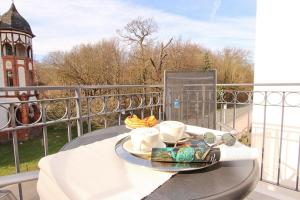 海利根达姆Ferienwohnung Atlantis的阳台上桌子上的托盘食物