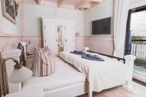 奥茨塞巴德·迪尔哈根Penthouse Meerblick的一间卧室设有两张床,墙上配有电视。