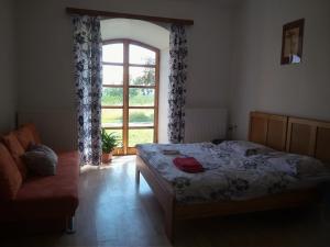 Borovná波罗乌内迪乌德酒店的一间卧室设有床、窗户和沙发