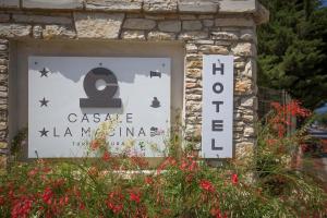 斯克佩罗Casale La Macina - Hotel, Scopello的石墙上卡萨码头的标志