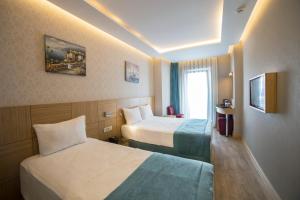 Meretto Hotel LALELİ客房内的一张或多张床位