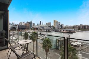 墨尔本Docklands Private Collection - NEWQUAY的阳台享有河流和城市美景。
