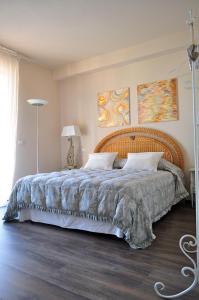 马里纳迪马萨海蓝宝石住宿加早餐旅馆的一间卧室配有一张大床和木制床头板