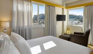 雅典Acropolis View Penthouse的酒店客房带一张床、椅子和窗户