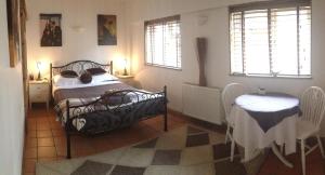 克劳利Tanglewood Gatwick Bed & Breakfast的卧室配有床、桌子和窗户。
