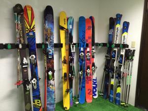饭山市斑尾巴赫高山酒店的一堆滑雪板靠墙排成一排