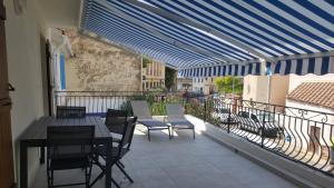 滨海圣芒德里耶Anatole - T3 - Moderne - Climatisé - 1er étage - Très grande terrasse - Vue magnifique et dégagée的阳台的天井配有桌椅