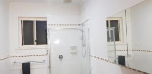 SturtUnit in Marion的带淋浴和镜子的白色浴室