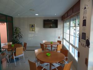波多诺伏海风旅舍的餐厅设有2张桌子和椅子以及窗户。