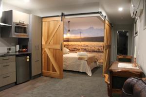 特卡波湖麦肯齐套房公寓的一间卧室配有床和滑动谷仓门。