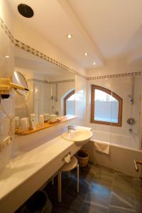 巴德小基希海姆奥特内斯埃斯岑霍夫 - 阿尔卑斯斯罗尼斯酒店的一间带水槽和淋浴的浴室