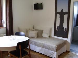 凯泽贝尔Marcia Donatti-A l'Ombre des Coteaux Rio de Janeiro的一间设有一张桌子和一面墙的床铺的房间